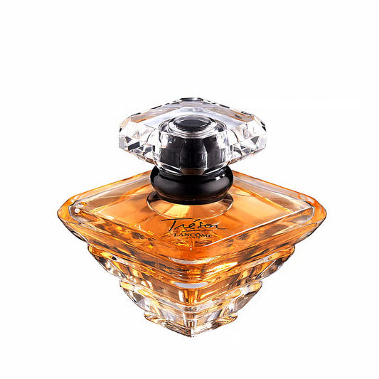 Lancôme Trésor EdP – en ikonisk diamantformad glasflaska som reflekterar en gyllene bärnstensfärgad vätska, krönt med en elegant svart ring runt halsen.